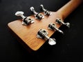 close up shot of acoustic guitar tuning machine, open gear