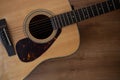 Close up shot of acoustic guitar on wooden table Royalty Free Stock Photo