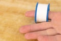 Close up shot of adhesive tape in the hand of a man