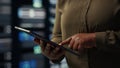 Close up shot of admin working in data center using tablet Royalty Free Stock Photo