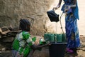 Close Up Shot of African Black Children Pouring Water from a Well into Bucket