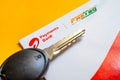 Close up shot of Airtel Payment bank Fastag and car key placed on yellow table showing the RFID payment by NHAI