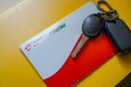 Close up shot of Airtel Payment bank Fastag and car key placed on yellow table showing the RFID payment by NHAI