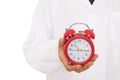 Close-up shot of alarm clock holding in doctor hands Royalty Free Stock Photo