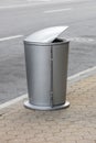 Aluminum trash can on walkway Royalty Free Stock Photo