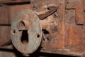 Close-up shot of an antique keyhole in a rusted iron plate on an old iron door Royalty Free Stock Photo