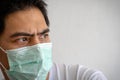 Close-up shot of Asian adult man wearing a protective medical face mask Royalty Free Stock Photo