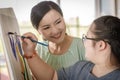 Close up shot of Asian happy lovely mother face standing smiling encouraging young chubby down syndrome autistic autism little Royalty Free Stock Photo