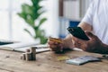 Close-up shot of Asian male hands holding bank card and smartphone. Royalty Free Stock Photo