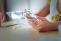 Close up shot Asian woman using clear tablet for futuristic cyber technology concept with HUD GUI User interface element hallow d Royalty Free Stock Photo