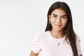 Close-up shot of attractive young and friendly indian teenage girl with earrings and necklaces smiling cute at camera as Royalty Free Stock Photo