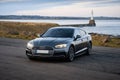 Close-up shot of an Audi s5 parked near a lake coast