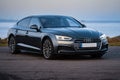 Close-up shot of an Audi s5 parked near a lake coast