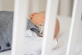 close-up shot of baby in crib with pacifier in mouth