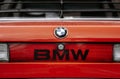 Close-up shot of the back of an orange classic retro BMW 320  car at a parking Royalty Free Stock Photo