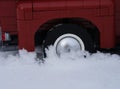 A close-up shot of a back wheel of a Lego Pickup Truck in snow