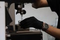 Close-up shot of Baretta hand filling hot water from fully automatic coffee machine. Royalty Free Stock Photo