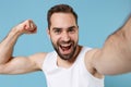 Close up shot bearded young man 20s years old in white shirt doing selfie isolated on blue pastel wall background