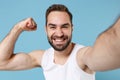 Close up shot bearded young man 20s years old in white shirt doing selfie isolated on blue pastel wall background