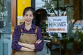 Close-up shot of a beautiful Asian coffee shop owner. small family job and the employment sign was affixed to the glass door. Royalty Free Stock Photo