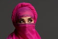 Close-up shot of a young charming woman wearing the pink hijab decorated with sequins. Arabic style. Royalty Free Stock Photo