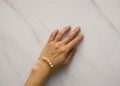 Close up shot of beautiful gold bracelet with pearls on the woman& x27;s hand Royalty Free Stock Photo