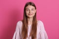 Close up shot of beautiful young woman model with dark hair looking at camera with charming cute smile while posing against rosy Royalty Free Stock Photo