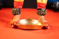 Close up shot of bharatnatyam kuchipudi artist dancing by balancing on edge of brass plate - concept of professional