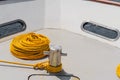 close up shot of a big bollard with a golden yellow rope tied to it Royalty Free Stock Photo