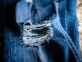 Close-up shot of blue fashionable stylish faded ripped denim jeans texture