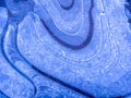 A close-up shot of a blue ice texture on a puddle in frosty winter weather