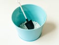 close-up shot of blue iron flowerpot bucket with white decorative stones and small shovel. Royalty Free Stock Photo