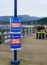 Close up shot of blue and red Social distance signs for Covid 19 at the Pier of Rocky Point Park in Port Moody, October 1st 2020