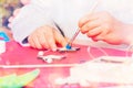 Boy decorating Christmas star with blue paint