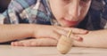 Close up shot of a boy spinning a Hanukka dreidel on the floor