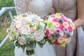 Bride and maid of honor or bridesmaid holding large colorful and sophisticated wedding bouquets Royalty Free Stock Photo