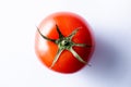 Close up shot of a red tomatoe on a white background Royalty Free Stock Photo