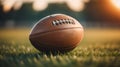 Close up shot of a brown leather football ball on grass football field American football .green background.AI generated Royalty Free Stock Photo