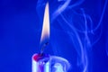 Close up shot of a burning candle on a blue background Royalty Free Stock Photo