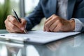 Close up shot of a businessman signing a business contract. Businessman writing on a paper document Royalty Free Stock Photo