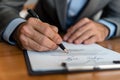 Close up shot of a businessman signing a business contract. Businessman writing on a paper document Royalty Free Stock Photo