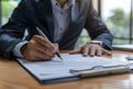 Close up shot of a businessman signing a business contract. Businessman writing on a paper document Royalty Free Stock Photo