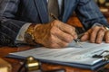 Close up shot of a businessman signing a business contract. Businessman writing on a paper document Royalty Free Stock Photo