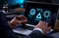 Businessman using a laptop with digital gears and settings display Royalty Free Stock Photo