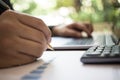 Close up shot of a businessman writing on charts paper at workstation. Modern business man writing on chart paper Royalty Free Stock Photo