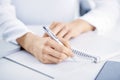 Businesswoman`s hand holding pen and writing something Royalty Free Stock Photo