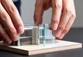 Architect& x27;s hands assembling a modern architectural model. Close-up of a designer working on a miniature building project for Royalty Free Stock Photo
