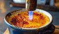 Caramelizing Sugar on Cr?me Br?l?e with a Torch Royalty Free Stock Photo