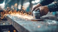 intensity and precision of a worker's hands using an angle grinder to smooth and shape a metal Royalty Free Stock Photo