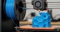 3D Printer in Action Creating a Blue Hexagonal Object Royalty Free Stock Photo